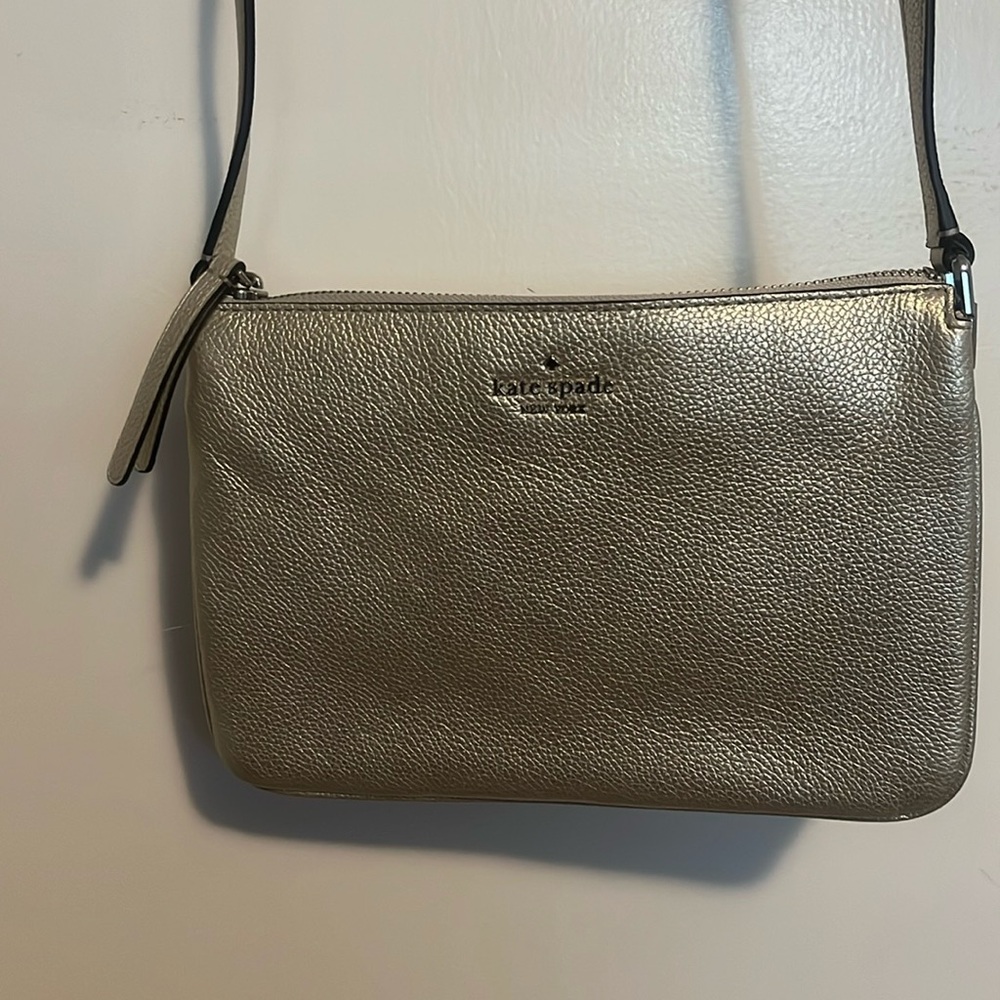 9.5 x 6 x 3 with adjustable strap. Zippered top with three interior sections